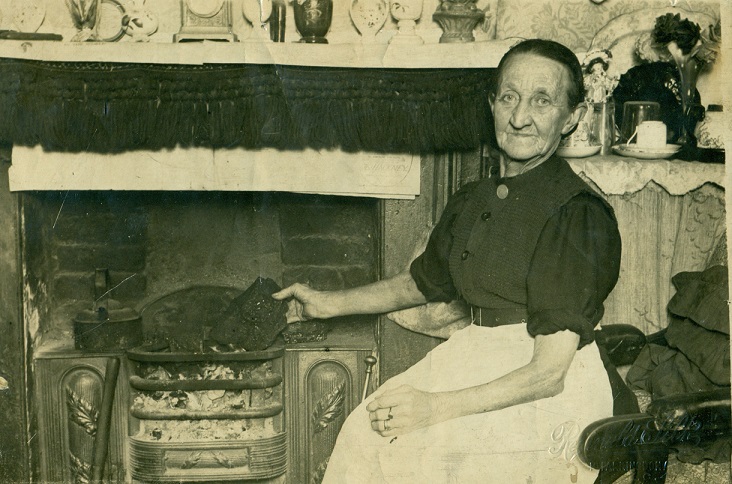Granny Sowden receiving the Queen’s Christmas gift of coal, photograph, 1920s.